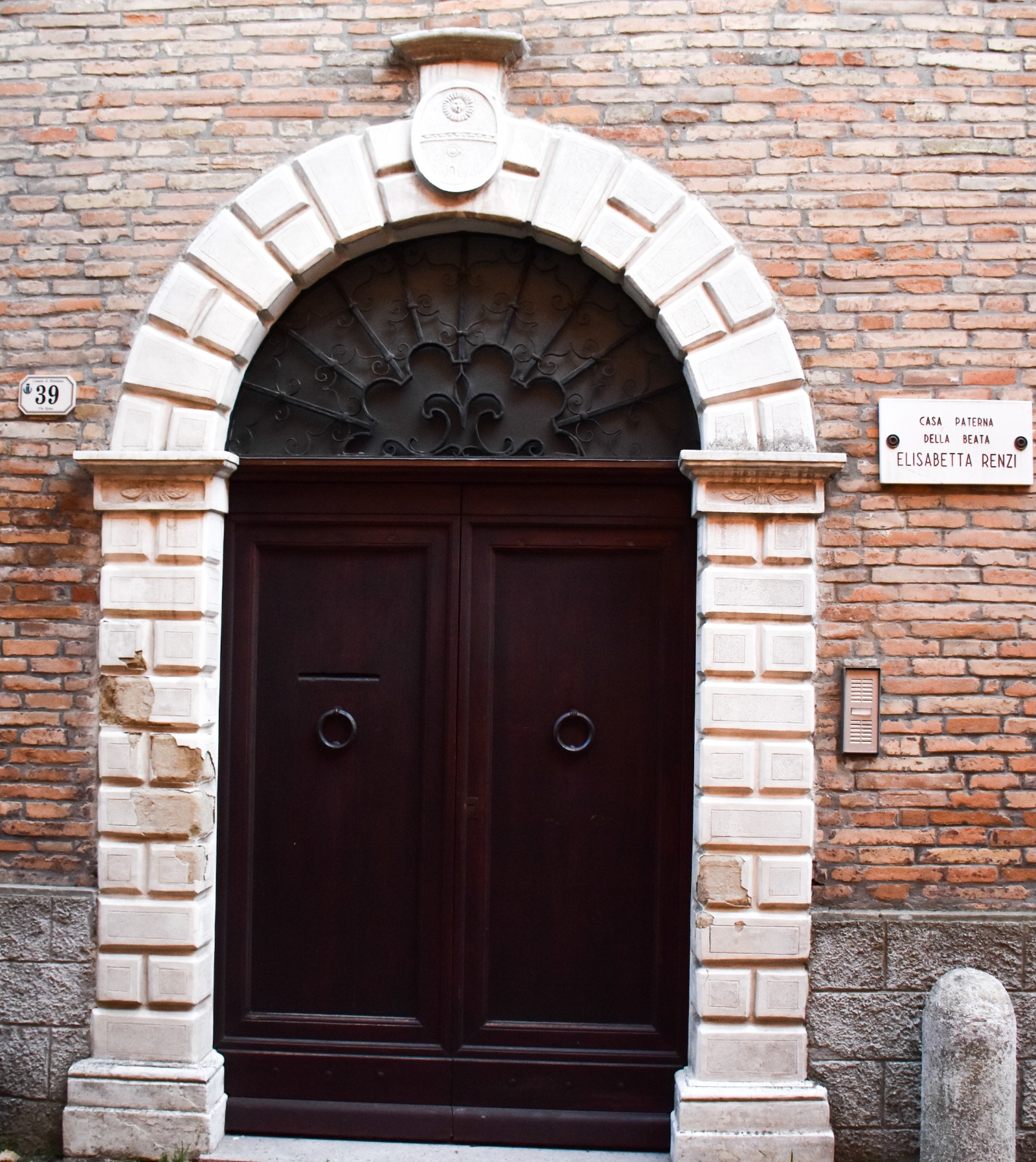 Wooden door entrance to Elisabetta's childhood home in Mondaino, Italy